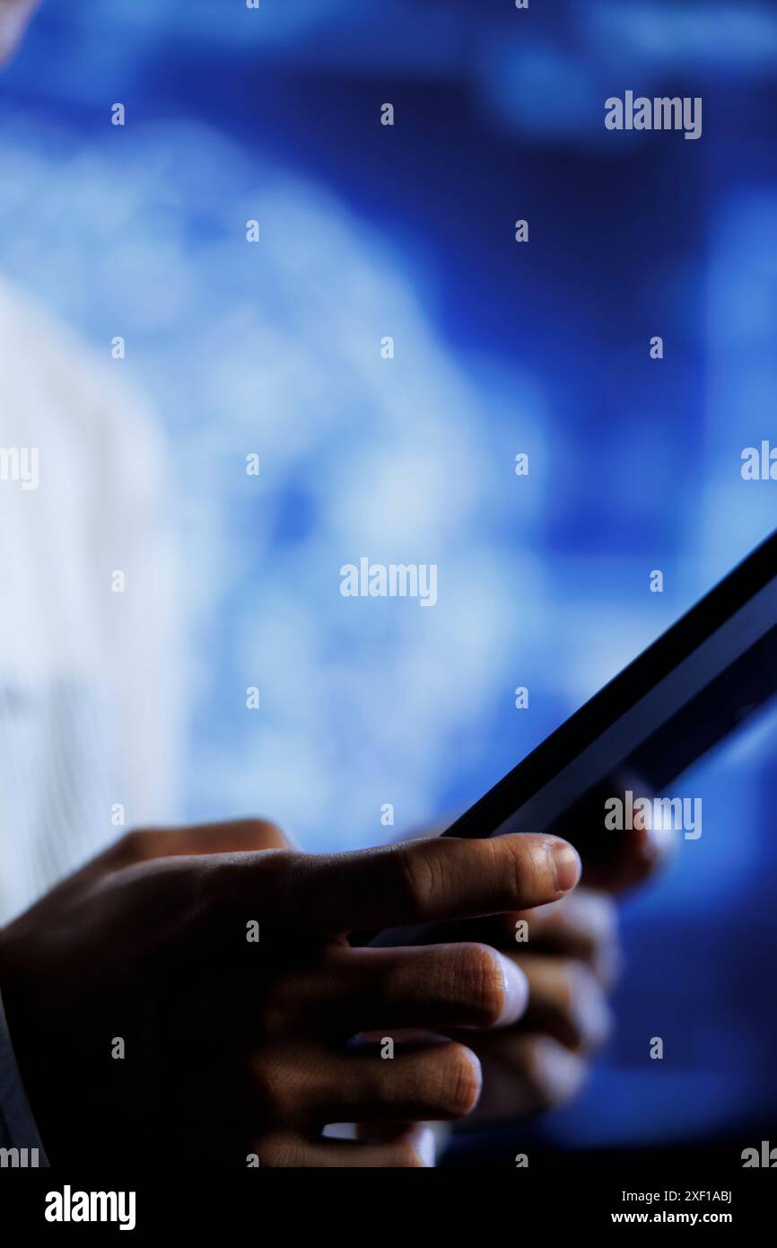 Programmer writes code on tablet to visualize artificial intelligence neural networks using augmented reality, close up. Qualified employee runs AI script for information processing Stock Photo
