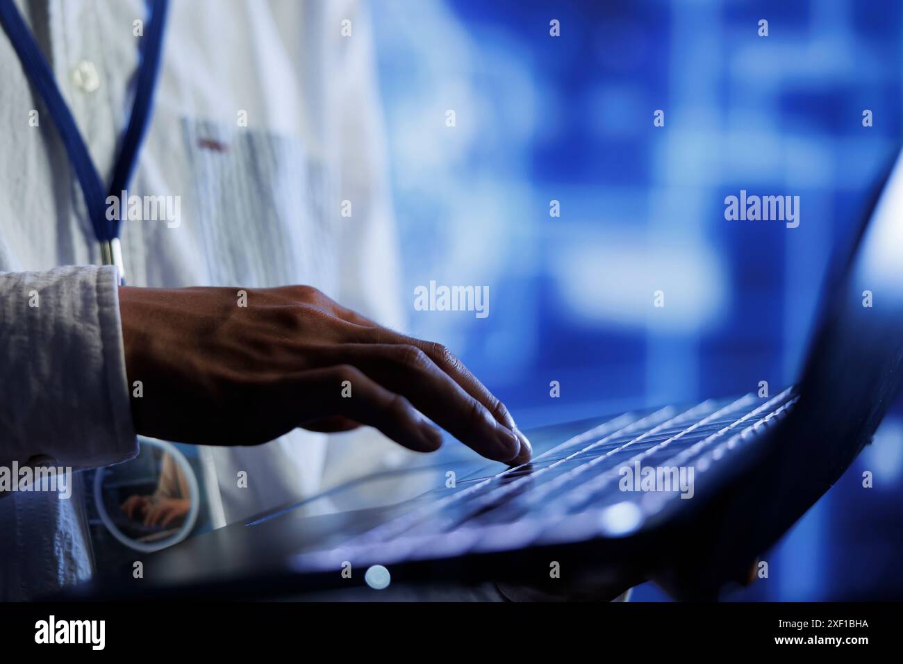 Trained developer writes code on laptop to visualize artificial intelligence neural networks using augmented reality, close up. Server farm specialist runs AI script for information processing Stock Photo