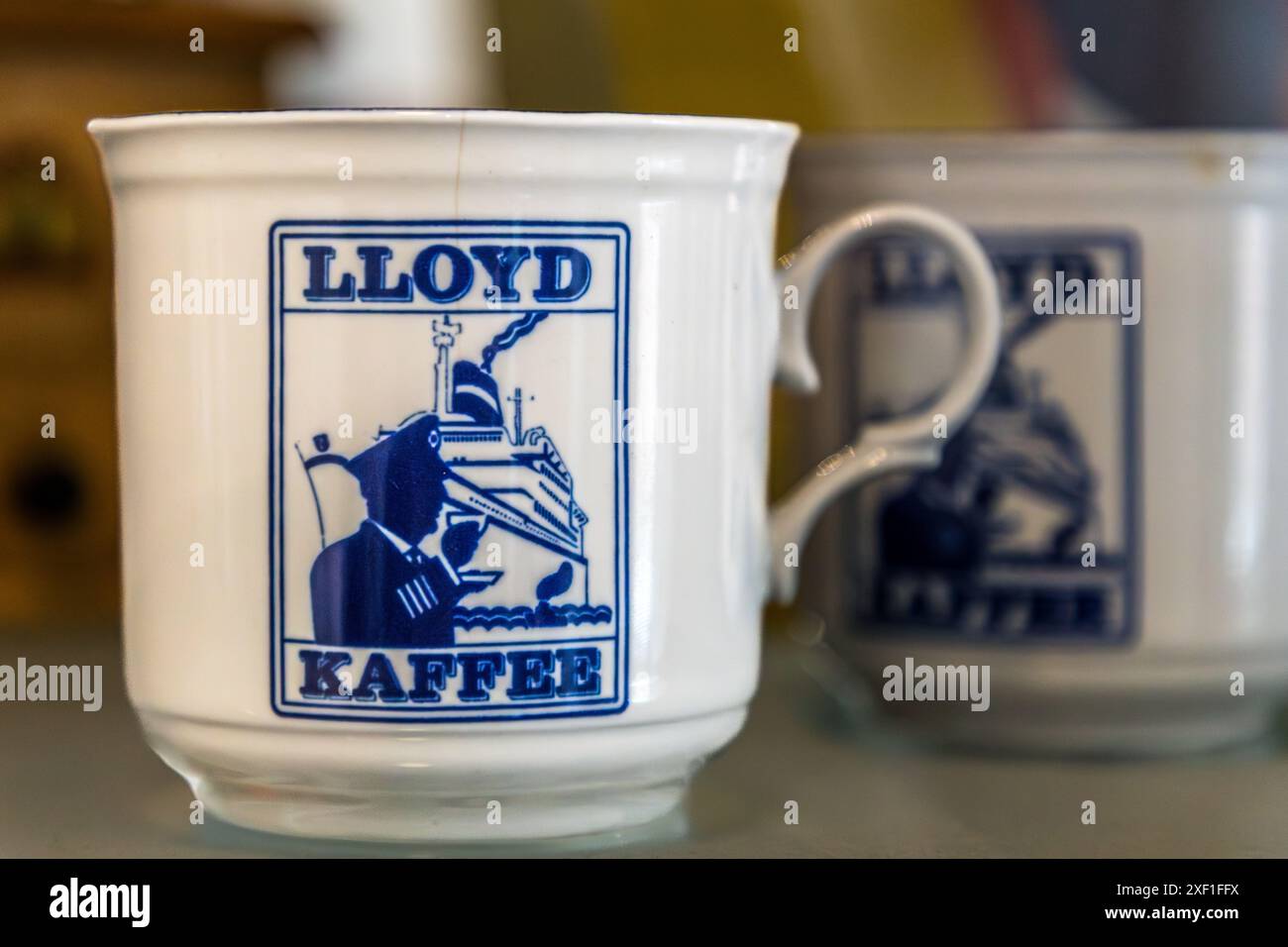 Mug with the Lloyd Caffee logo, a coffee-drinking captain with an ocean liner. Tasting room of the Lloyd Caffee Manufaktur, Bremen, Germany Stock Photo