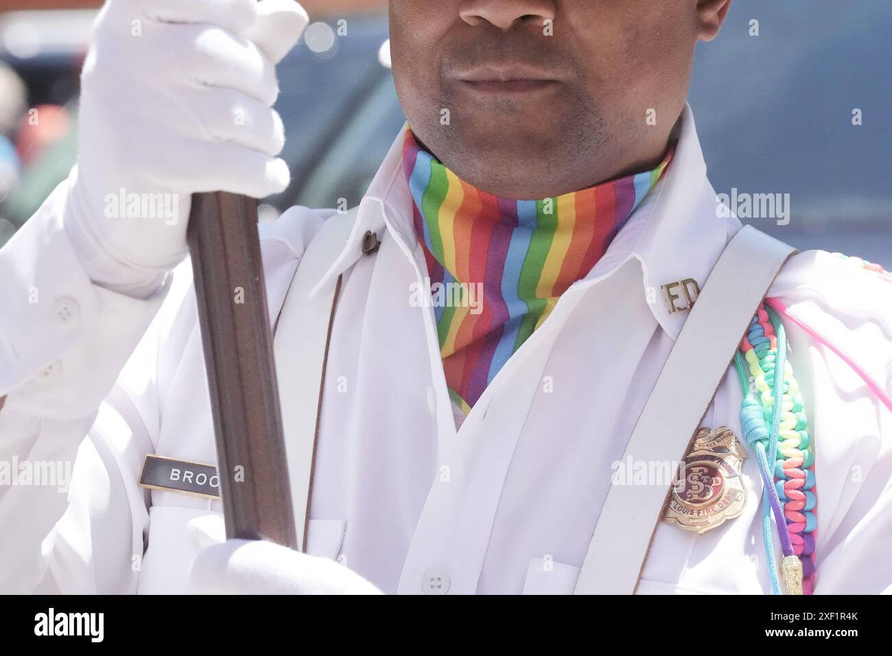 St. Louis, United States. 30th June, 2024. A member of the St. Louis Fire Department honor guard carries a flag, wearing a colorful ascot during the St. Louis Pride Parade in St. Louis on Sunday, June 30, 2024. Photo by Bill Greenblatt/UPI Credit: UPI/Alamy Live News Stock Photo