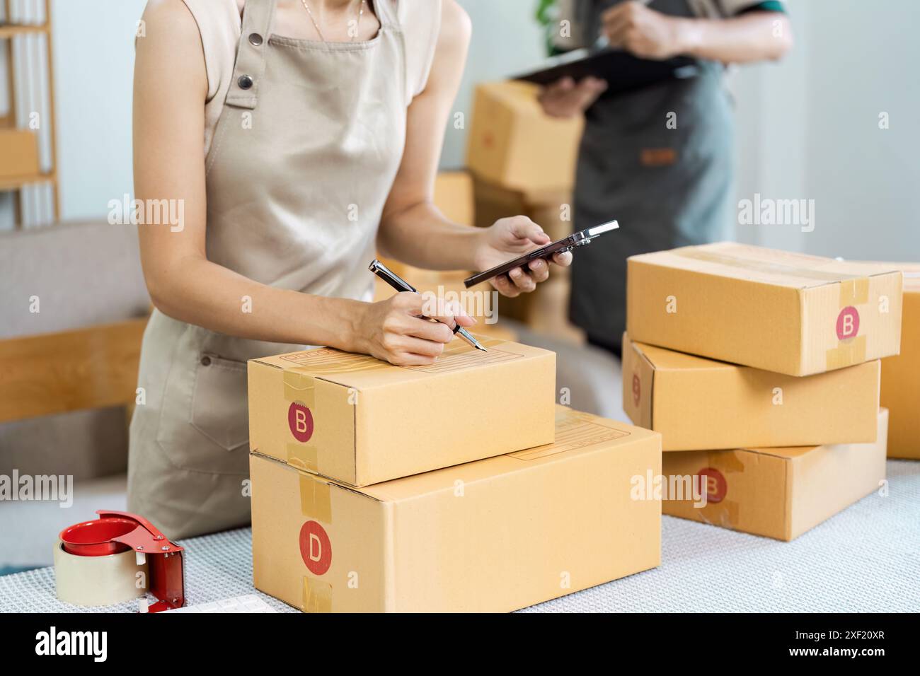 Small Business Owner Preparing Packages for Online Shipping in a Modern ...