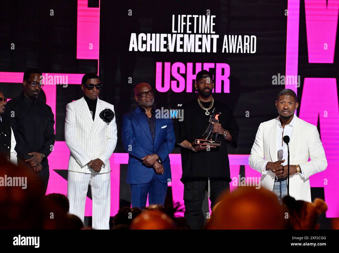 Usher accepts his Lifetime Achievement Award onstage during the 24th