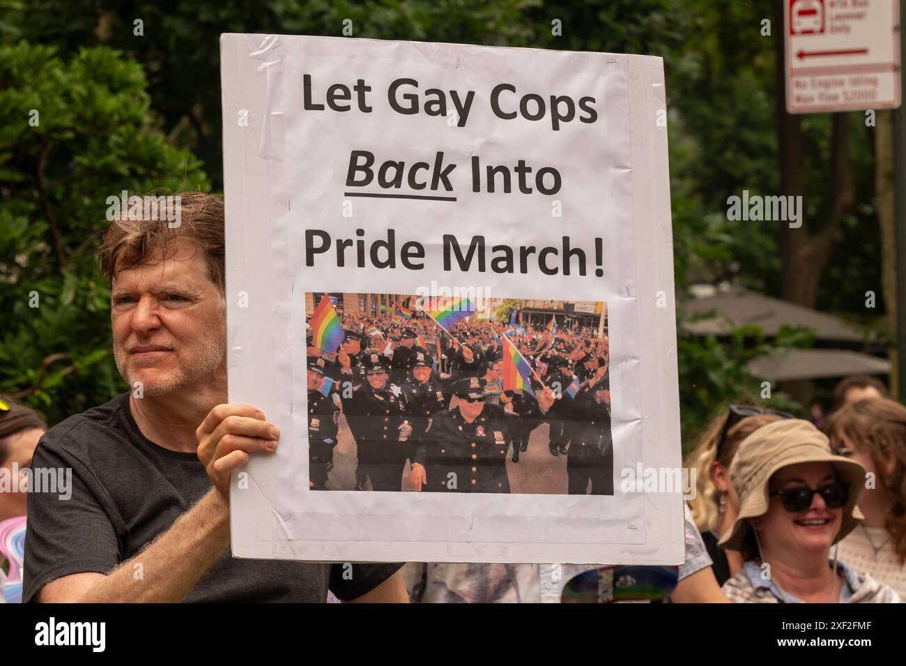 NEW YORK, NEW YORK - JUNE 30: A spectator holds a 'Let Gay Cops Back Into Prode March!' sign during the annual New York City Pride Parade on June 30, 2024 in New York City. (Photo by Ron Adar / SOPA Images/Sipa USA) Stock Photo