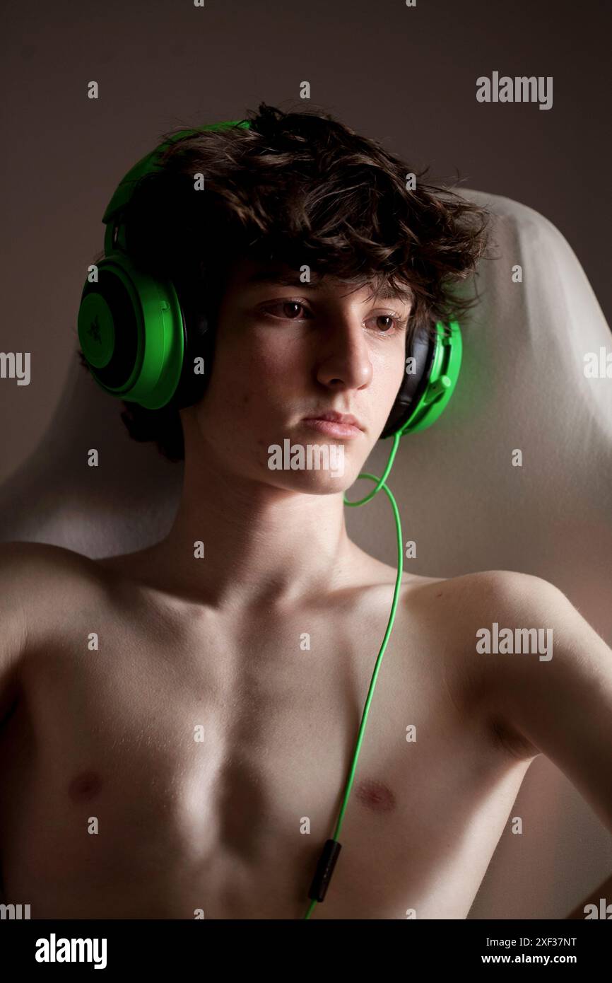 Teenage boy wearing gaming headphones Stock Photo - Alamy