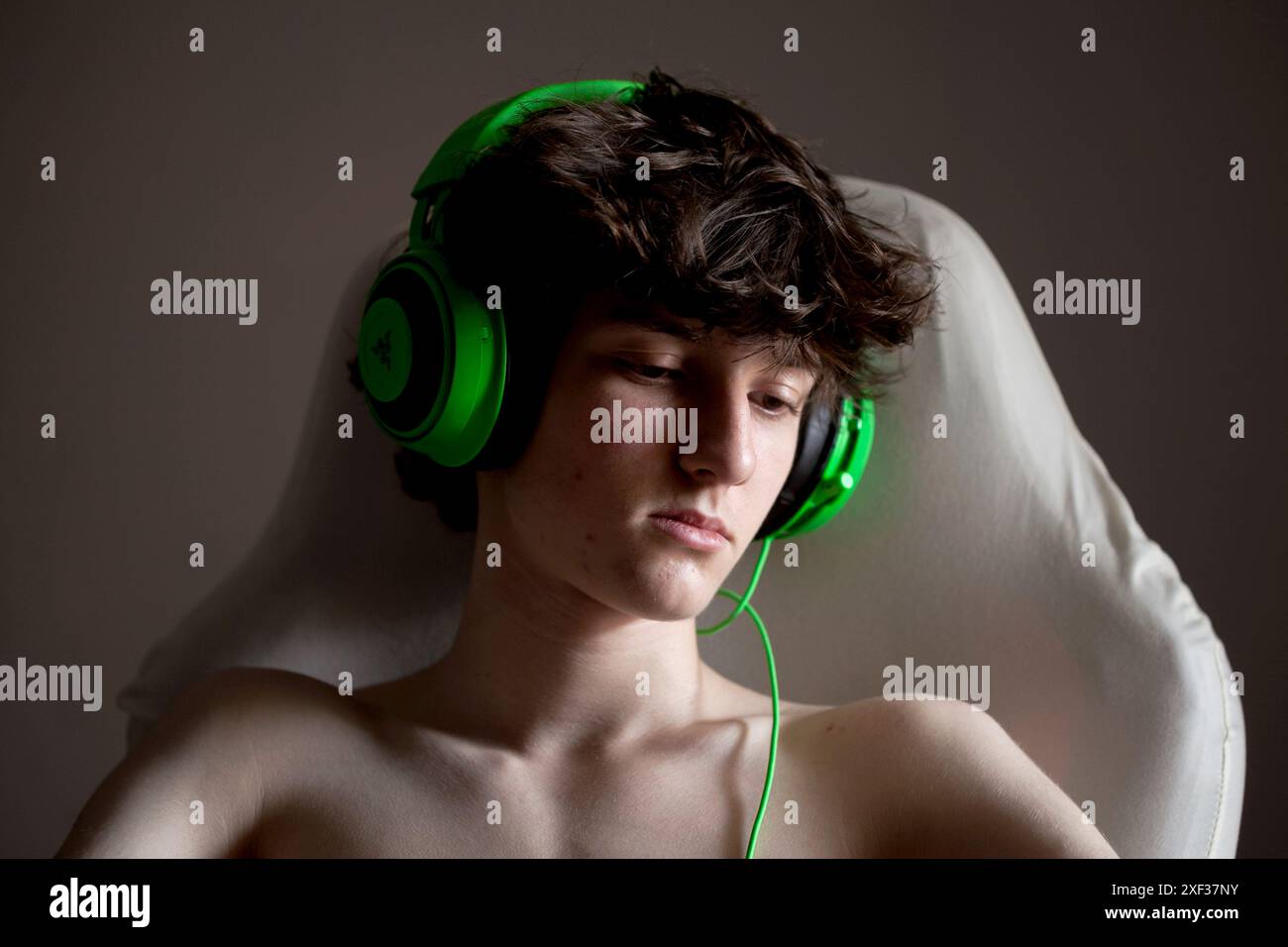 Teenage boy wearing gaming headphones Stock Photo - Alamy
