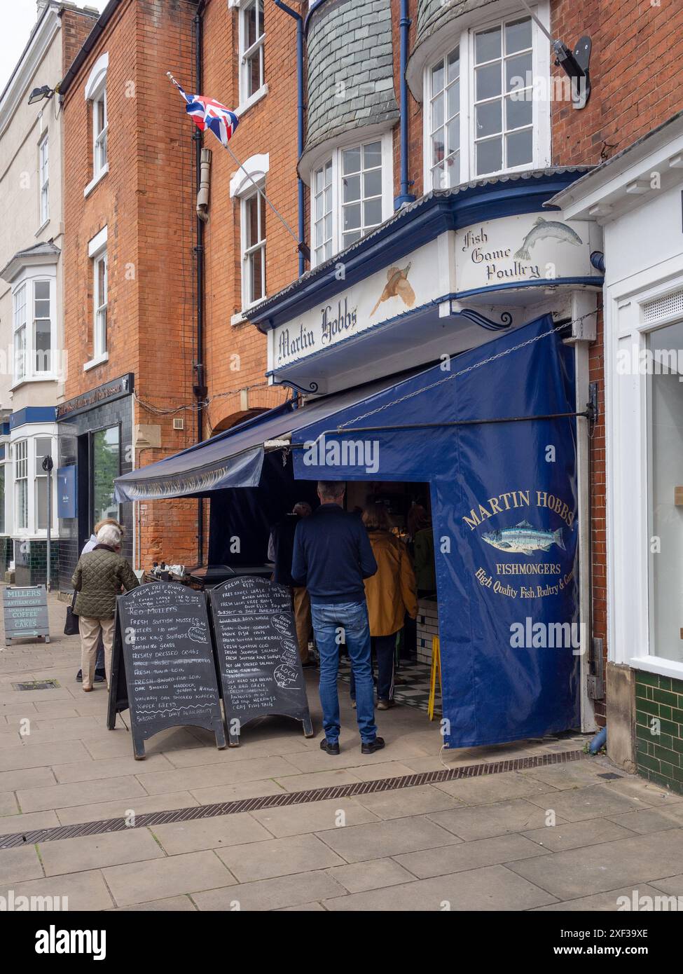 Customers queuing to purchase fresh fish at Martin Hobbs fishmonger, Market Harborough, Leicestershire, UK Stock Photo