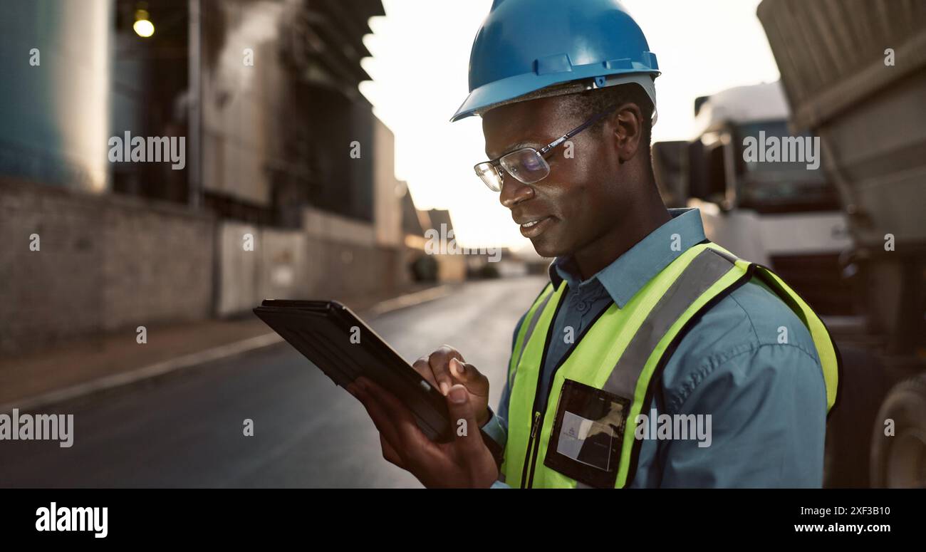 Construction site, planning and black man on tablet in city for ...