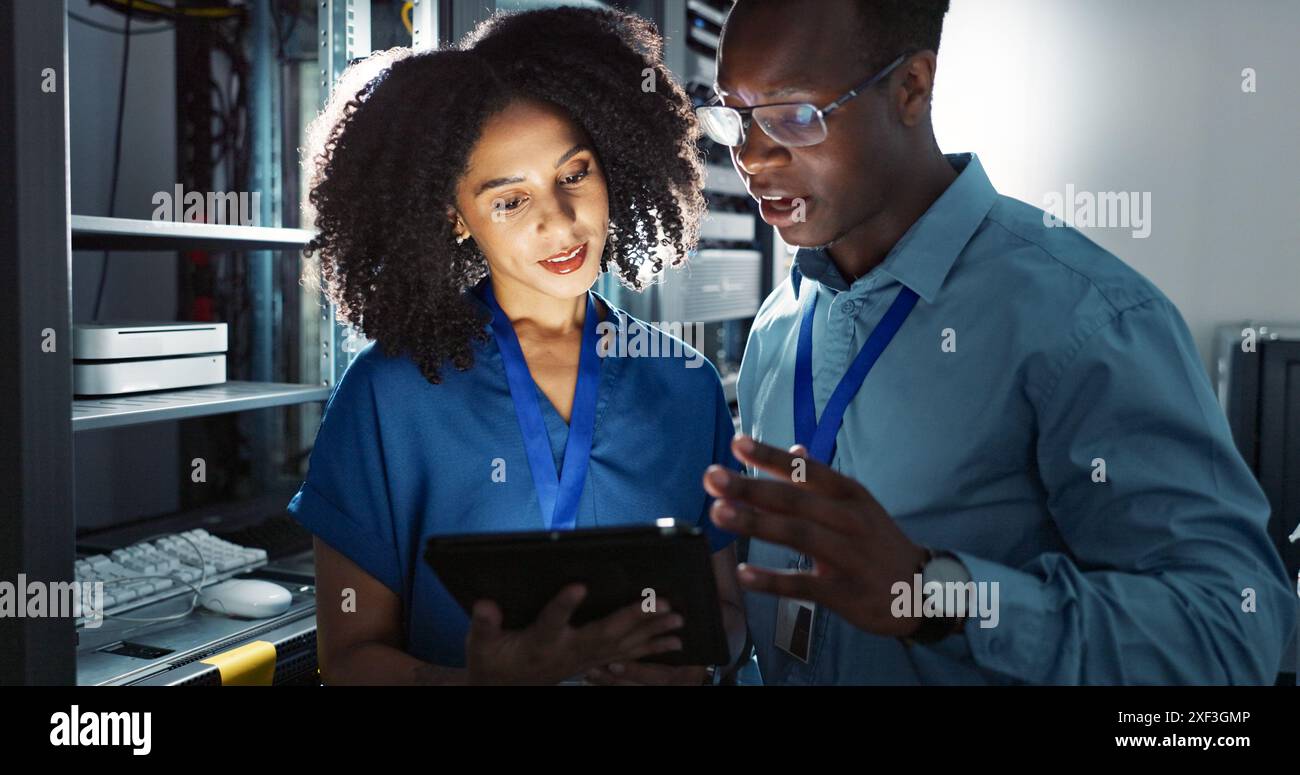 Server room, people and digital tablet for inspection, maintenance and system update. Software management, programmer and teamwork for problem solving Stock Photo
