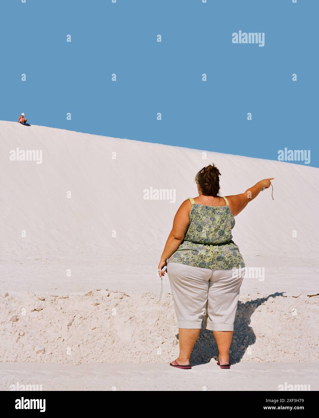 Pointing Near Obese woman pointing near sand dunes Stock Photo - Alamy