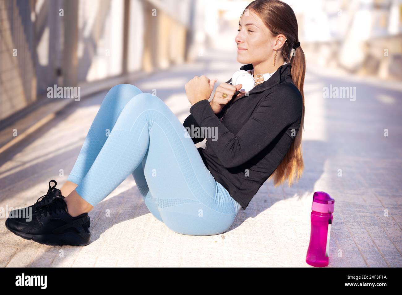 Active runner doing warm-up ABS for running or cardio. Stock Photo