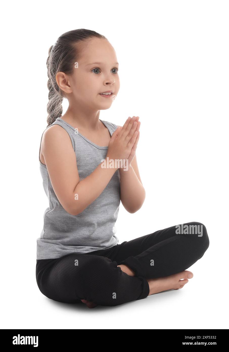 Cute little girl practicing yoga on white background Stock Photo - Alamy