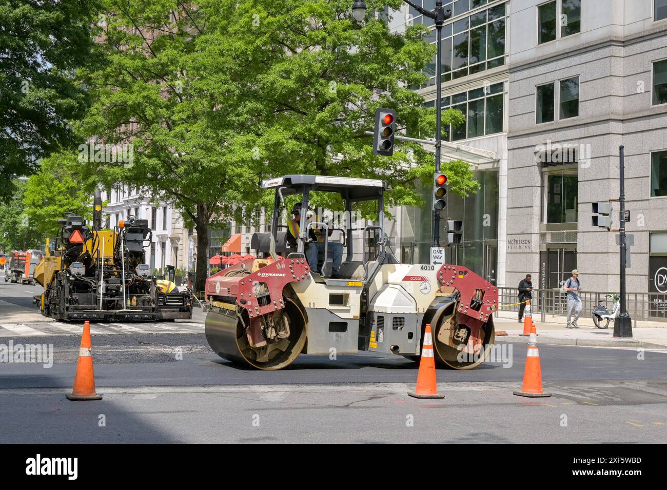 Washington DC, USA - 30 May 2024: Road roller being used on the resurfacing of tarmac on a road in downtown Washington DC Stock Photo