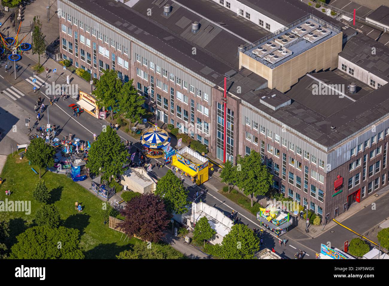 Aerial view, Himmelfahrtskirmes on the Ruhrstraße at the building of the Sparkasse Witten headquarters, carousel and stalls, Witten, Ruhr area, North Stock Photo