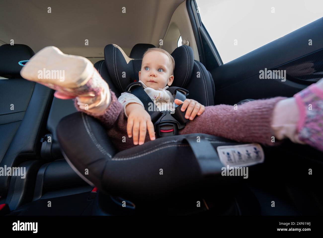 Baby safely seated in car seat for road trip. Concept of secure travel ...