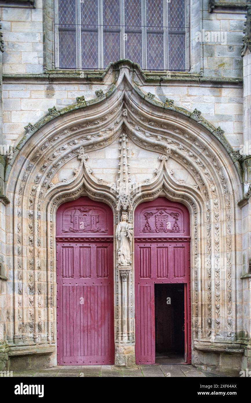 Detailed view of the Gothic entrance of Notre Dame du Roncier Basilica in Josselin, Brittany, France. Elaborate stonework and sculpted figures adorn t Stock Photo