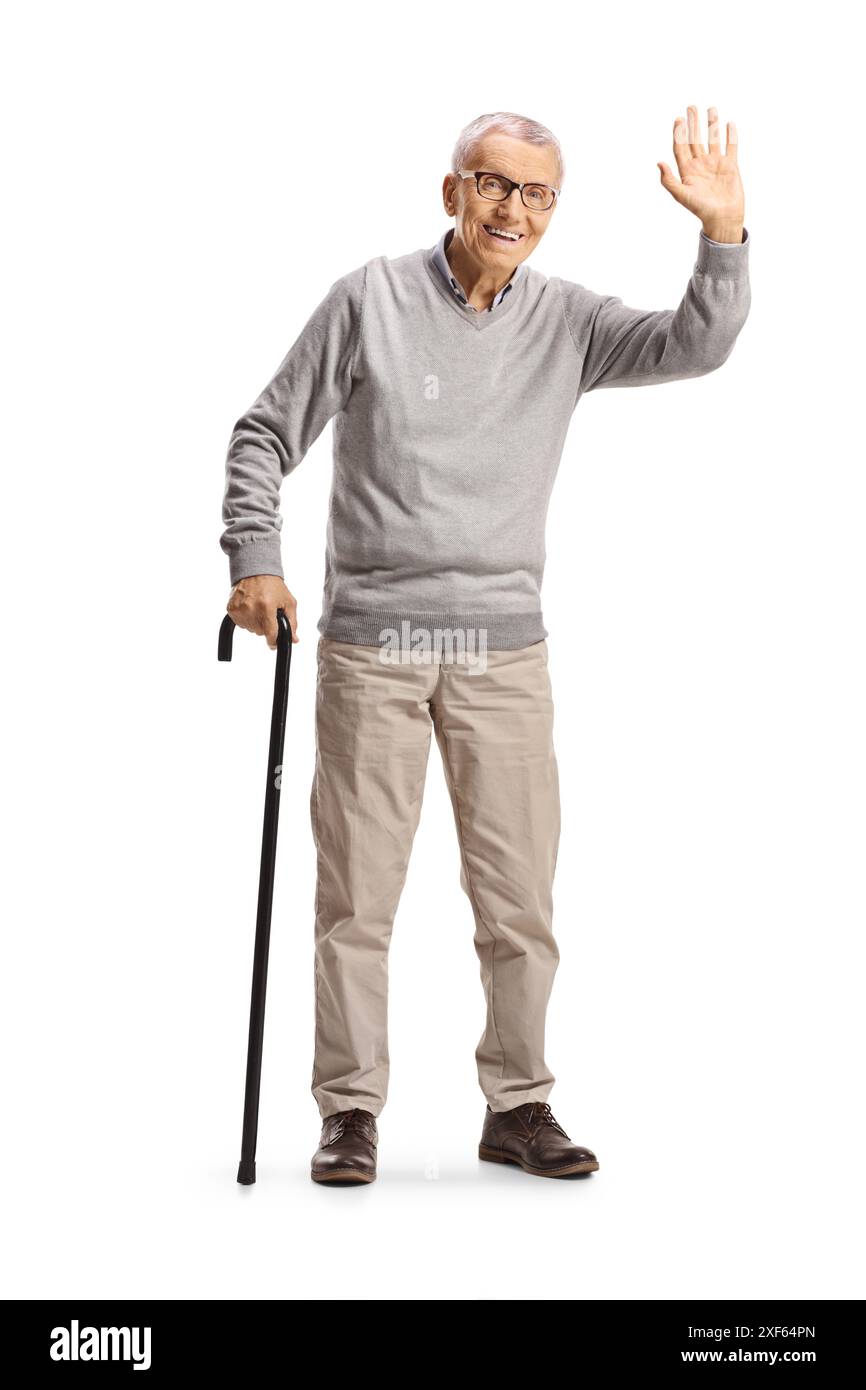 Happy elderly man with a walking cane waving isolated on white ...