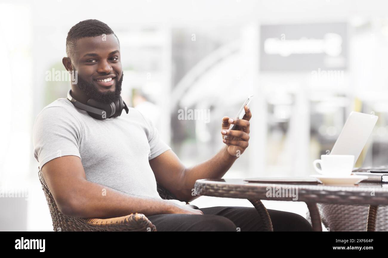 Man Using Smartphone at Cafe Stock Photo