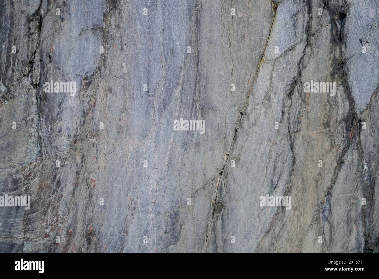 A close-up texture of a rough stone surface with natural patterns and ...