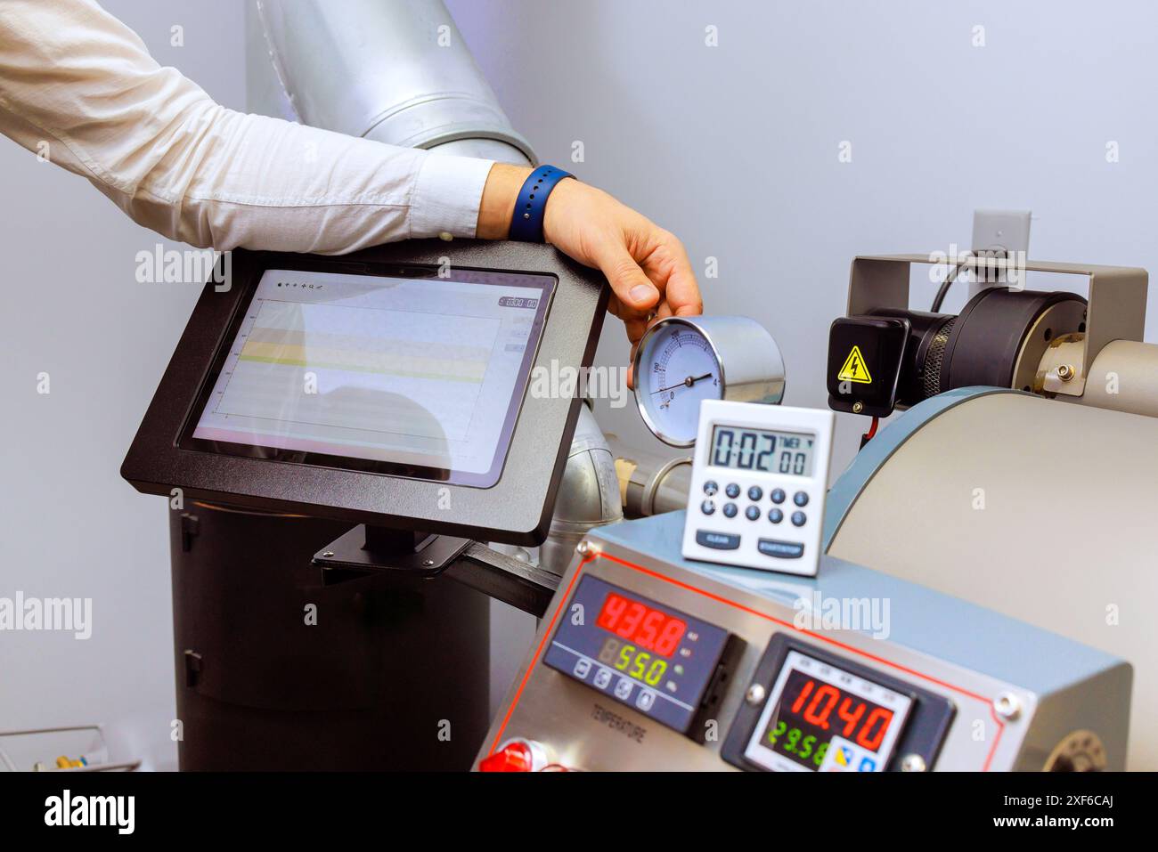 Roasting machine is used to bake raw coffee beans Stock Photo