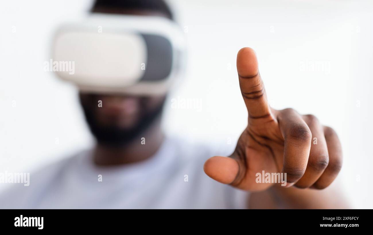 Man Wearing Virtual Reality Headset Interacts With Digital Content Stock Photo