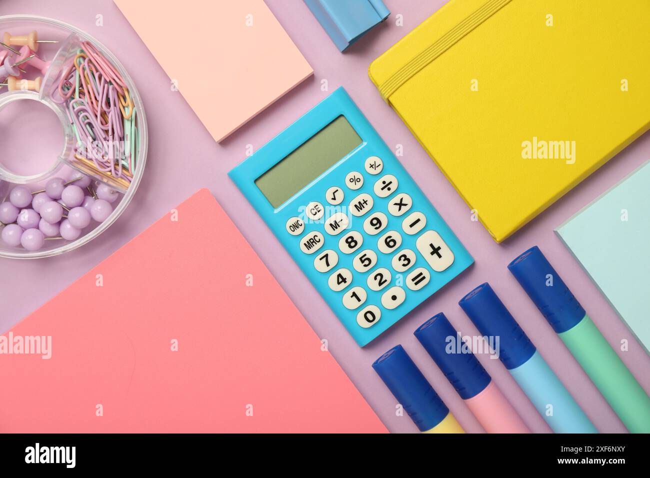 Flat lay composition with notebooks and different stationery on violet background Stock Photo