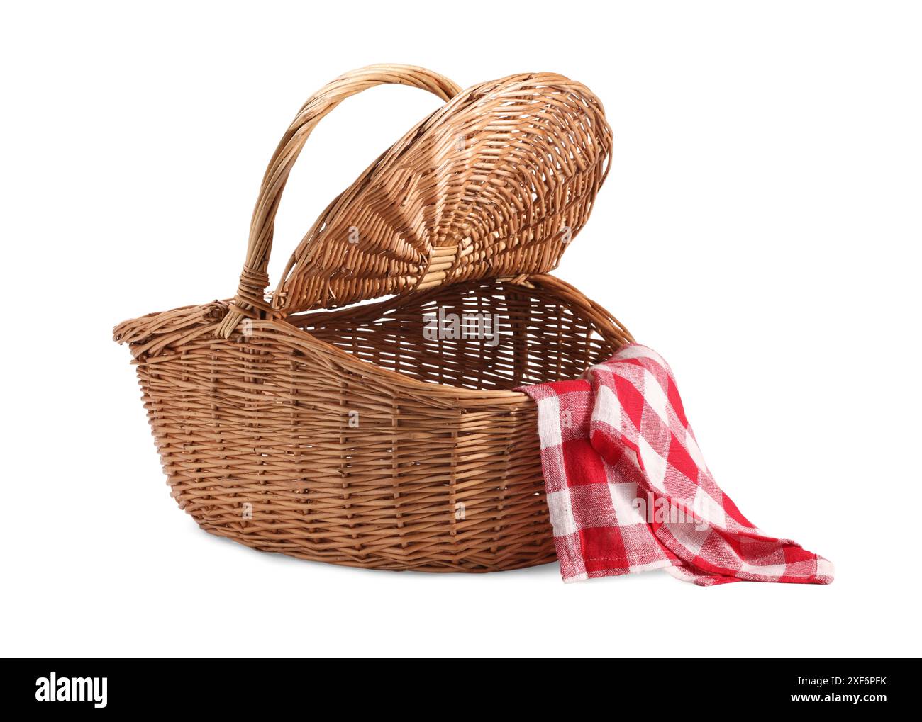 One open picnic wicker basket with checkered napkin isolated on white ...
