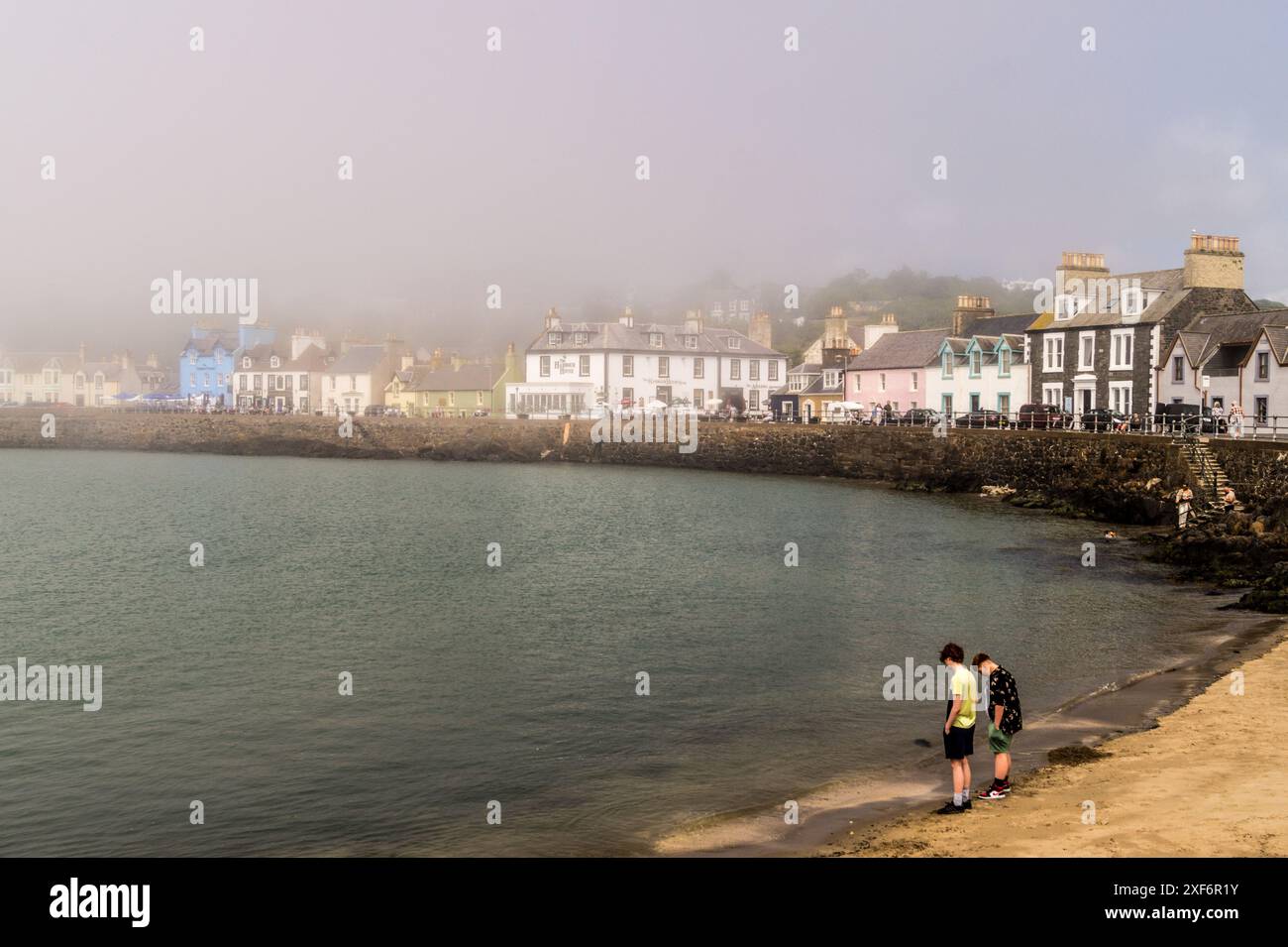 Harbour and Georgian seafront promenade of Portpatrick, in fog, Wigtownshire, Dumfries and Galloway, Scotland Stock Photo