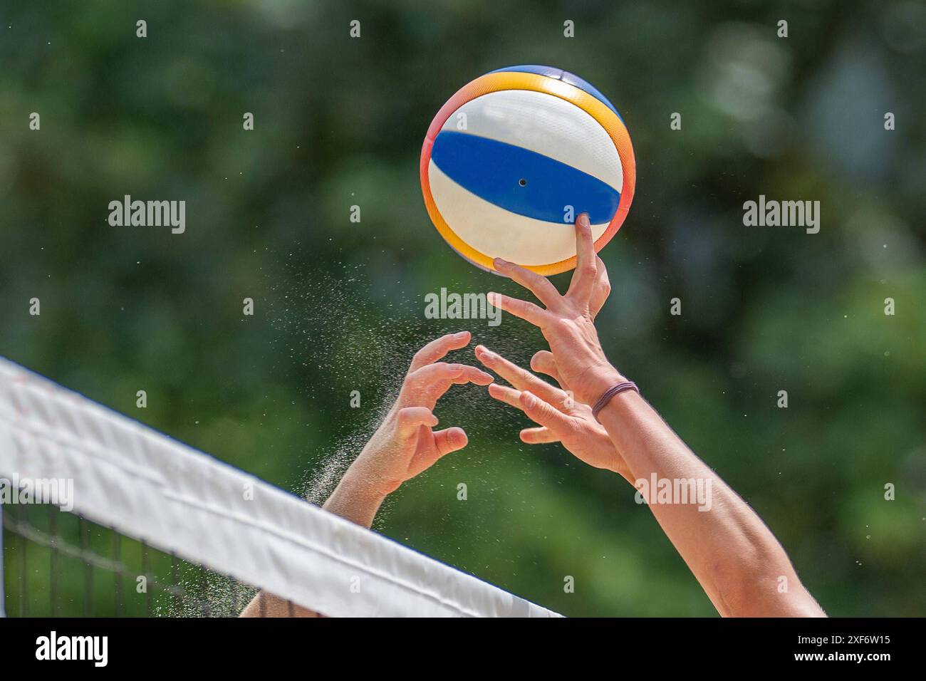 Beach volleyball game with hands and net Kitzbühel Schwarzsee Tirol