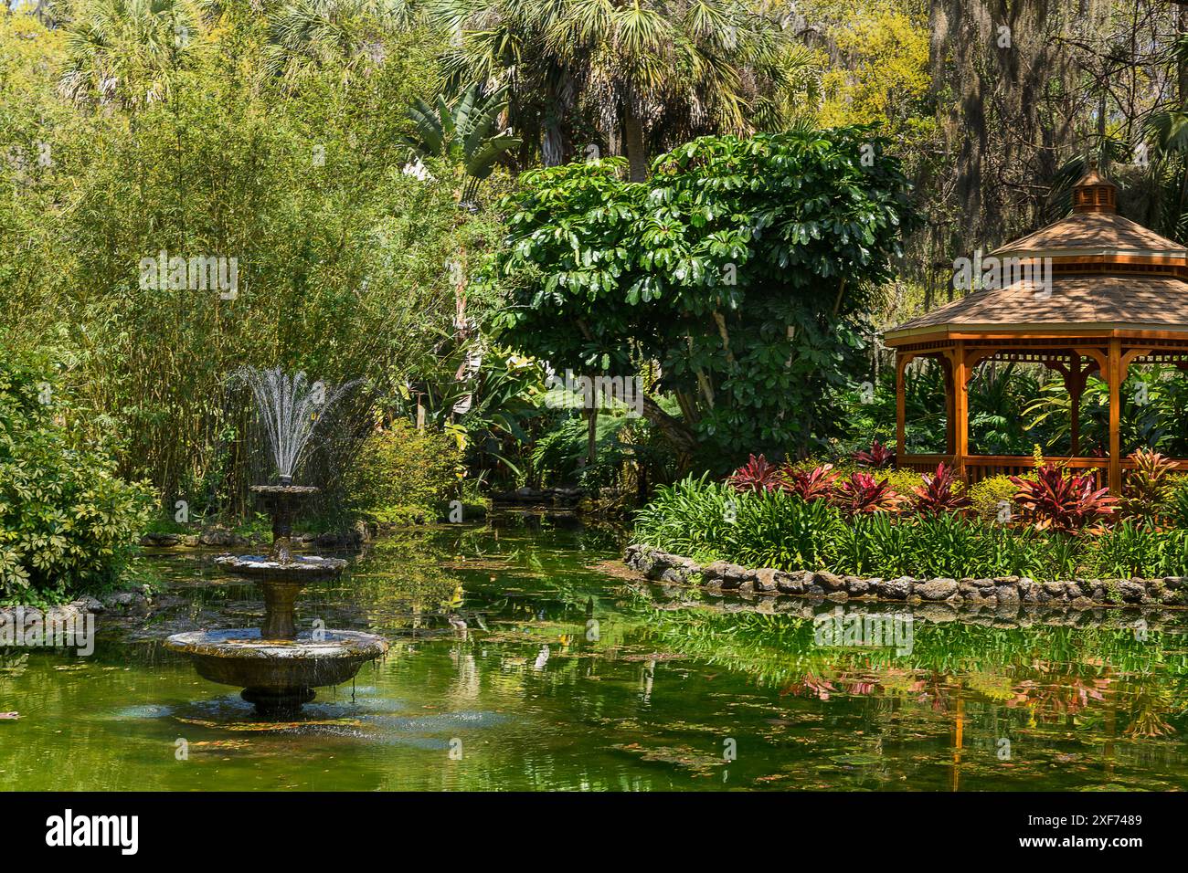 Gazebo fountain and pond reflecting in the water Stock Photo - Alamy