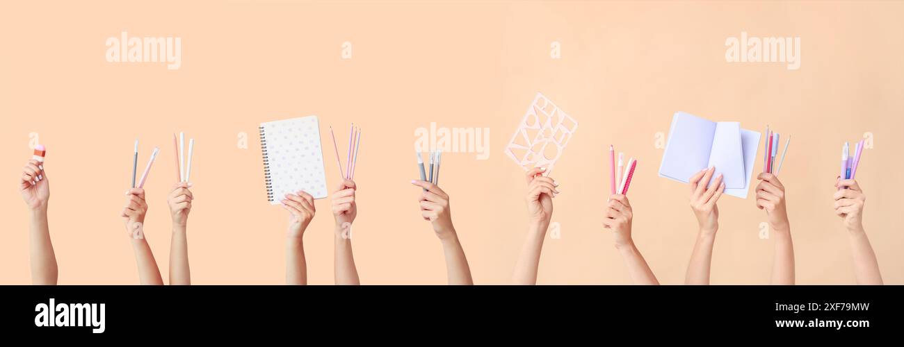 Many hands with school supplies on beige background Stock Photo - Alamy