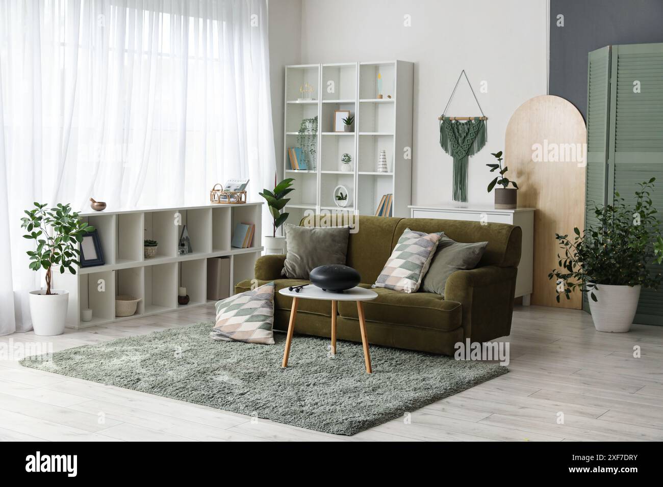 Interior of living room with green sofa and glucophone on table Stock Photo