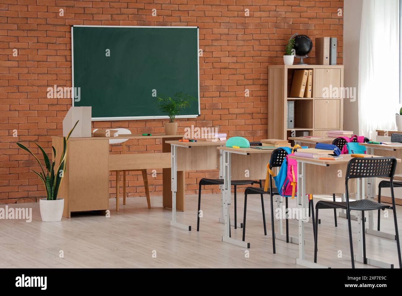Interior of classroom with chalkboard, desks and backpacks Stock Photo ...