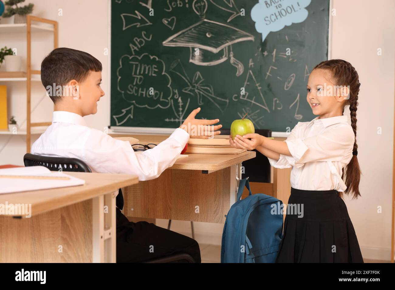 Giving Apple Little girl giving apple boy hi-res stock photography and images - Alamy