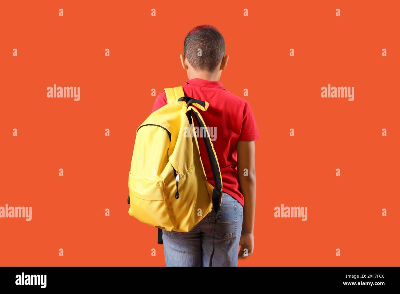Little schoolboy with backpack on orange background, back view Stock ...