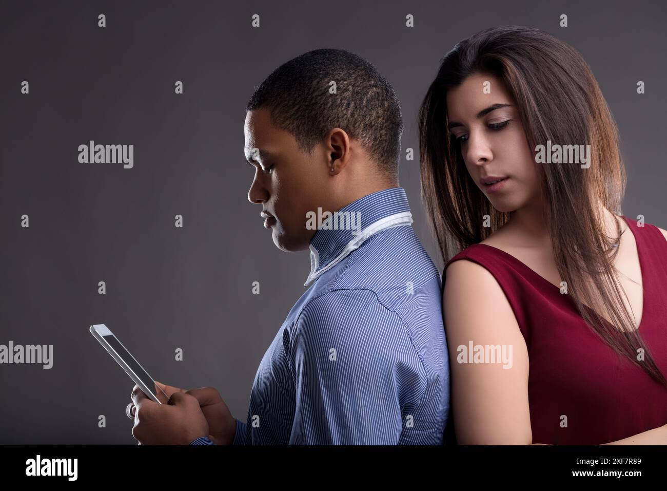 Woman Look Behavior suspicious woman leans over a man's shoulder as he looks at his phone ...