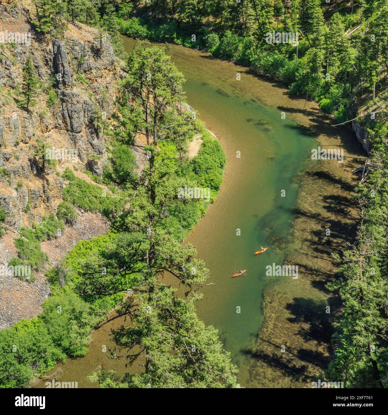 kayakers floating down the blackfoot river in a canyon near ovando