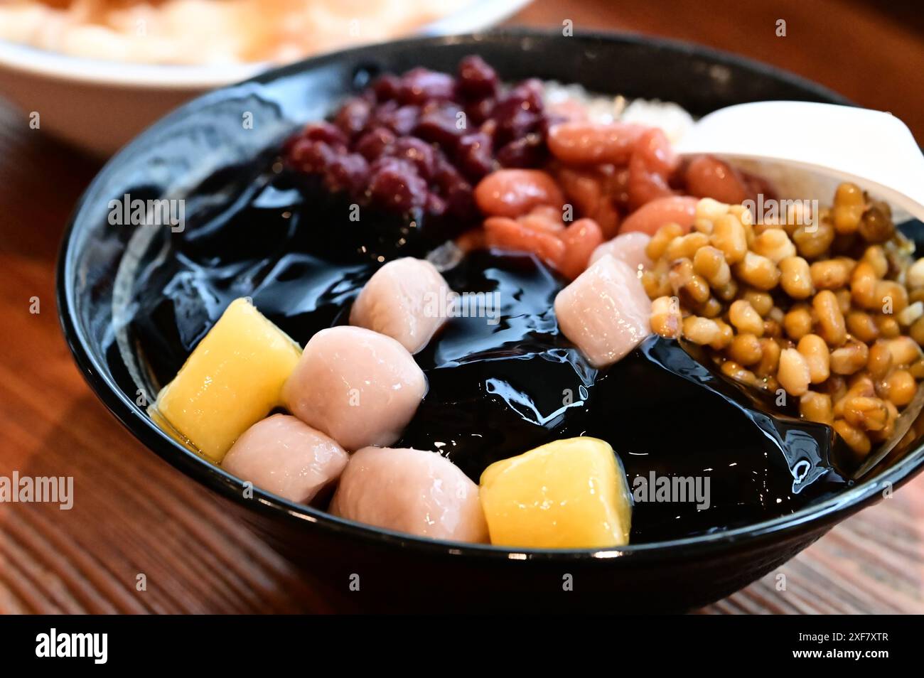 Summer Cool Down: Refreshing Taro Ball Shaved Ice. A beloved summer treat with shaved ice, taro balls, sweet potato balls, sugar water. Stock Photo