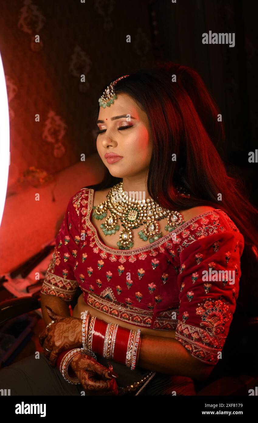 A Young Indian Bride Getting Makeup Applied For A Traditional Indian A young indian bride getting makeup applied for a traditional indian