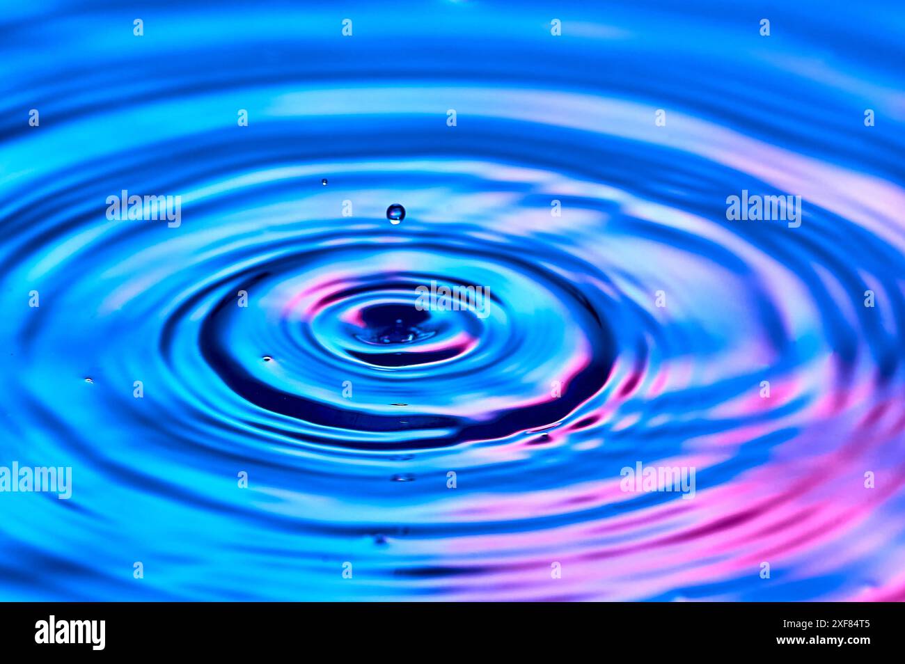 a drop of water falling into the water and creating waves Stock Photo ...