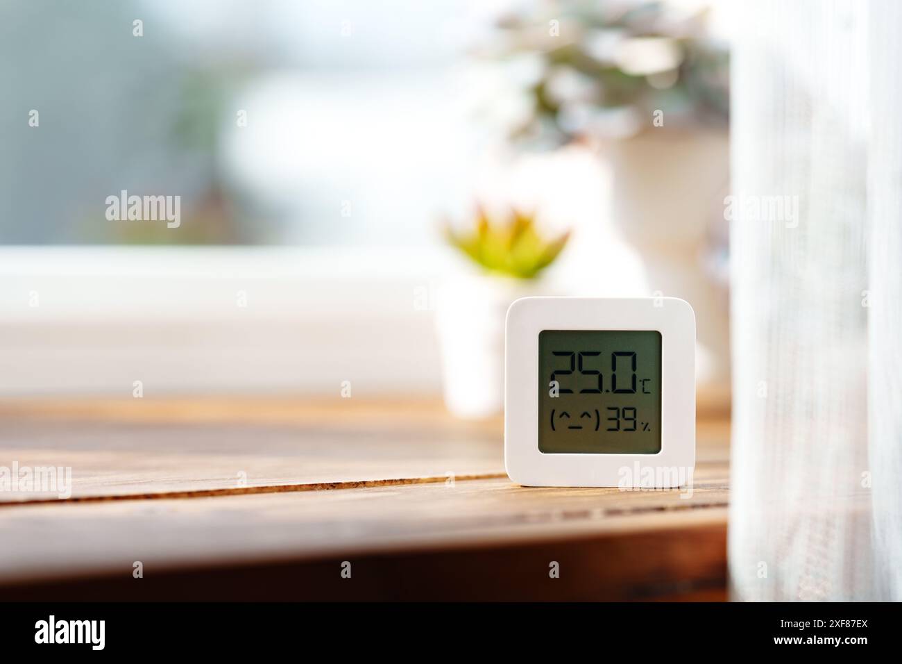Digital Thermometer Displaying Temperature and Humidity Near Window ...