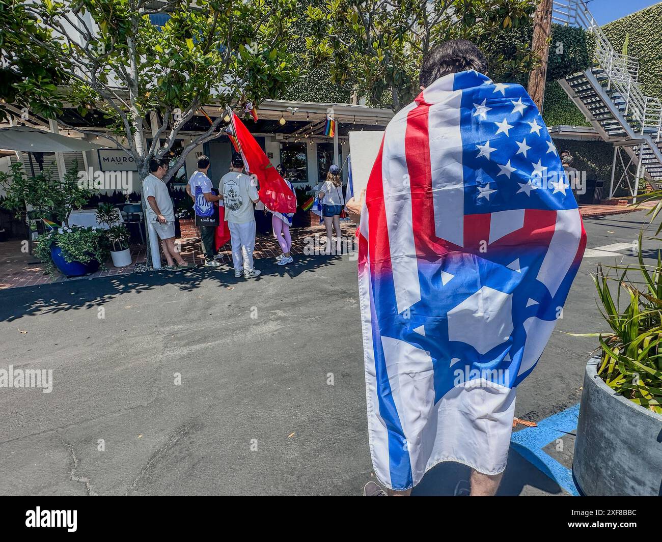 June 30, 2024, West Hollywood, California, USA: Jews who witnessed or heard about the bloody attack by Pro-Palestine protestors on the Adas Torah synagogue in the Orthodox neighborhood of Pico-Robinson one week ago sought to hold accountable one Keffiyeh, blond woman with a bull horn on June 30, by leading a small and peaceful but raucous Pro-Israel counter-protest and boycott in front of the patio of her West Hollywood restaurant, Mauro's cafe, a popular eatery with the Jewish community, until this week. (Credit Image: © Amy Katz/ZUMA Press Wire) EDITORIAL USAGE ONLY! Not for Commercial USA Stock Photo