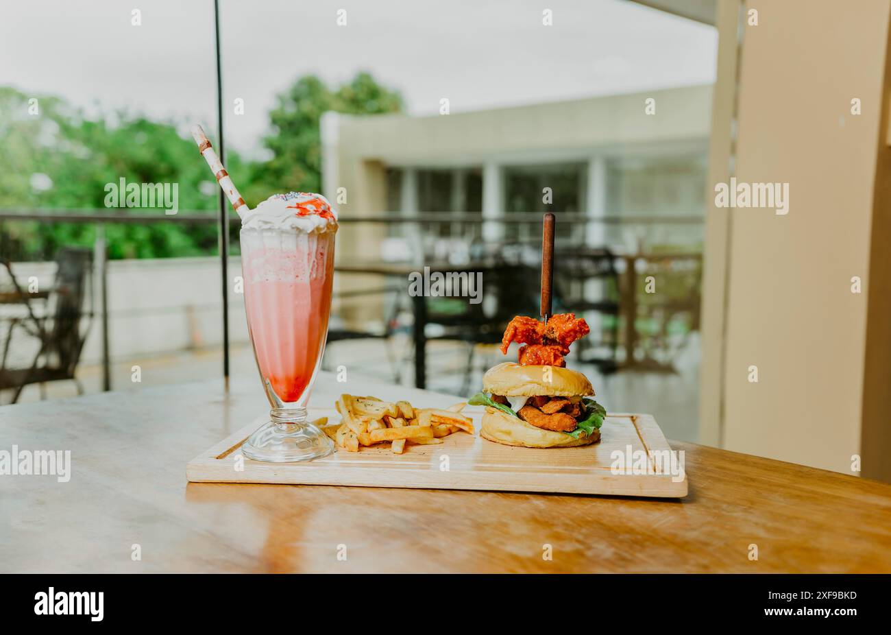 Traditional chicken burger with french fries and strawberry milkshake