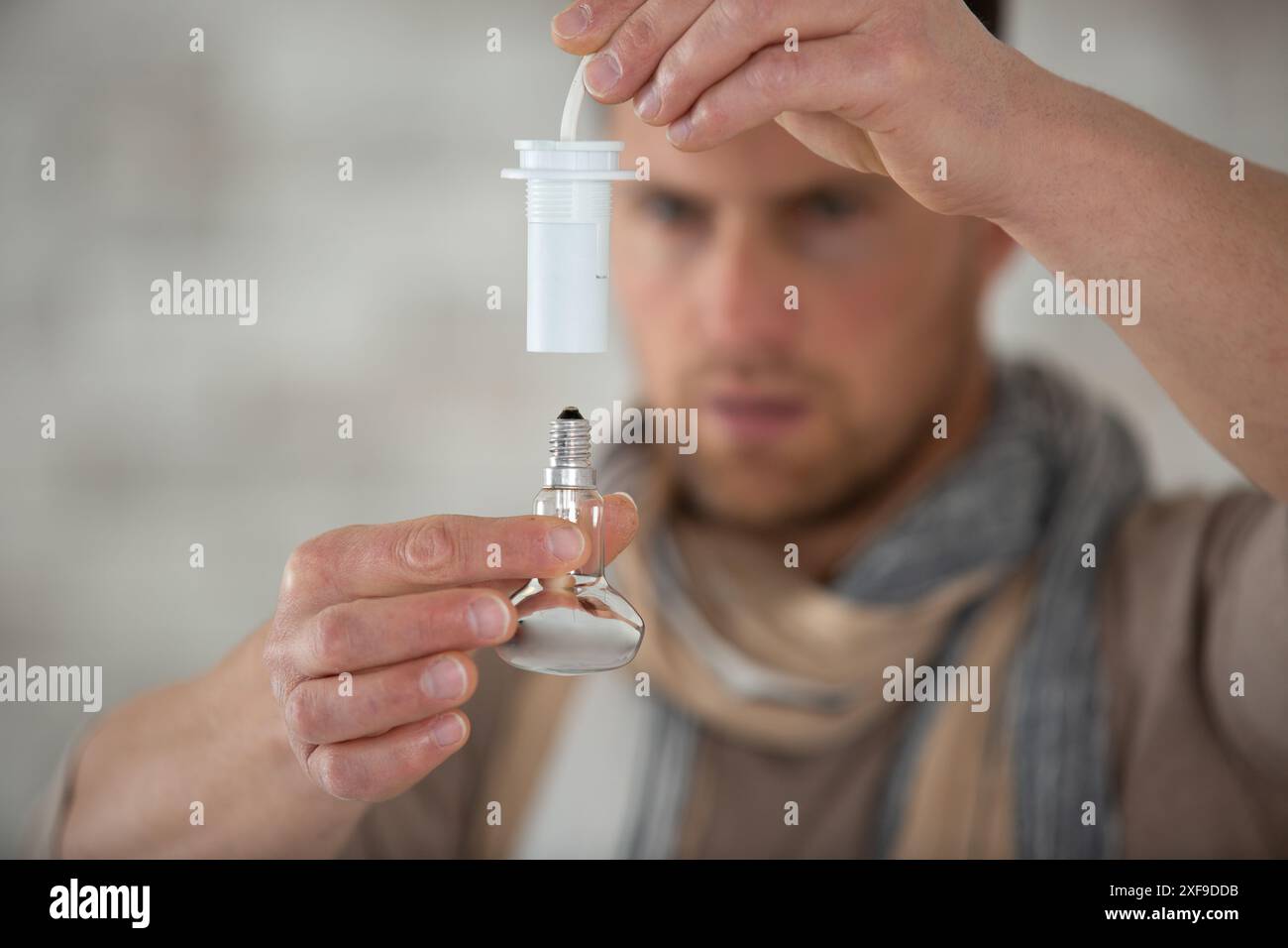 electrical engineer installing ceiling lamps in the hallway Stock Photo