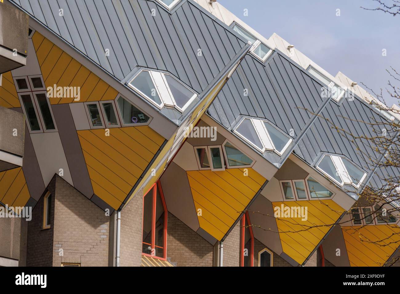 Cubist houses with yellow and grey pitched roofs and large windows ...