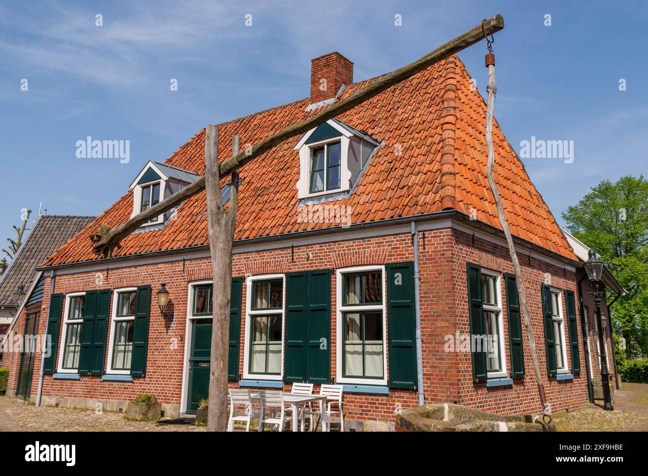 Historic brick house with fountain and windows under a blue sky in the ...