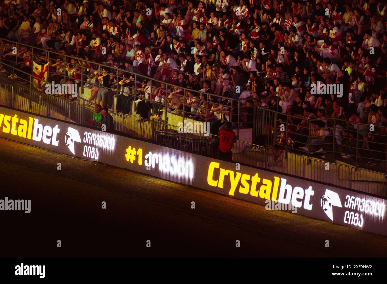 Tbilisi, Georgia - 20th june, 2024: Georgia - Spain match in Euro 2024 championship. Georgian supporters in tribunes. Crystalbet betting company organ Stock Photo