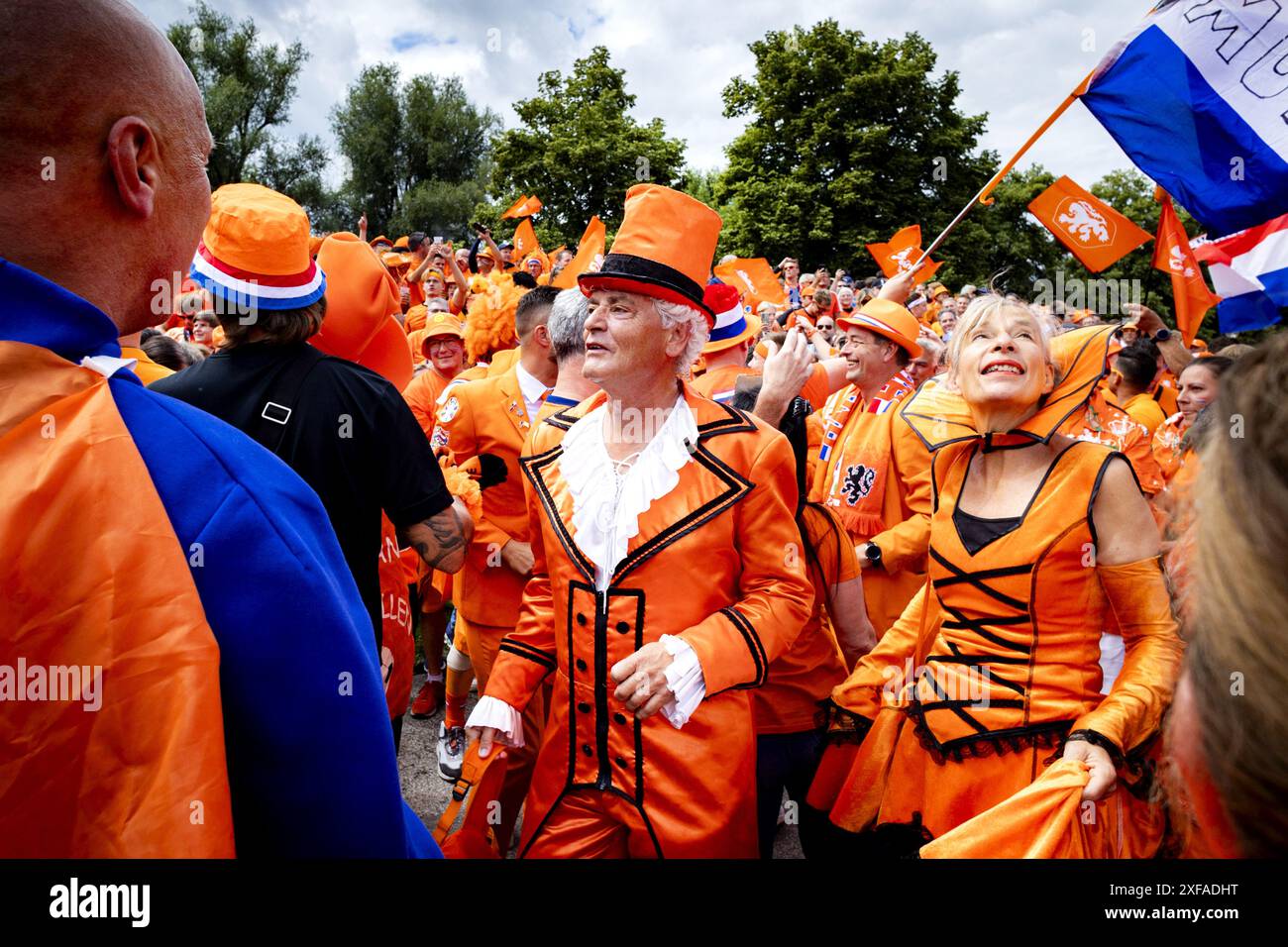 MUNICH - Dutch fans walk behind the Oranjebus during the fan walk to ...