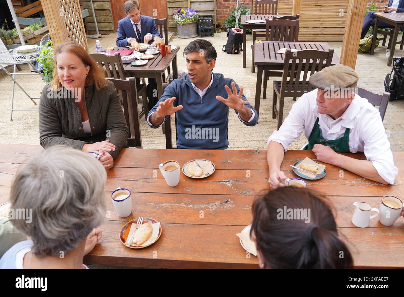 Prime Minister Rishi Sunak and Attorney General and parliamentary candidate for Banbury, Victoria Prentis, (left) speaking to staff in a cafe during a visit to Wykham Park Farm in Banbury, Oxfordshire, while on the General Election campaign trail. Picture date: Tuesday July 2, 2024. Stock Photo