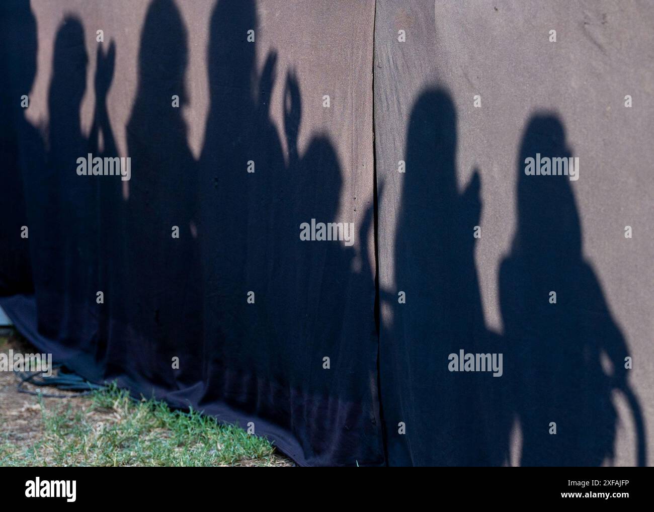 Party Time. Crowd Shadows on Outdoor Music Stage Enjoying Summer Fun. Stock Photo