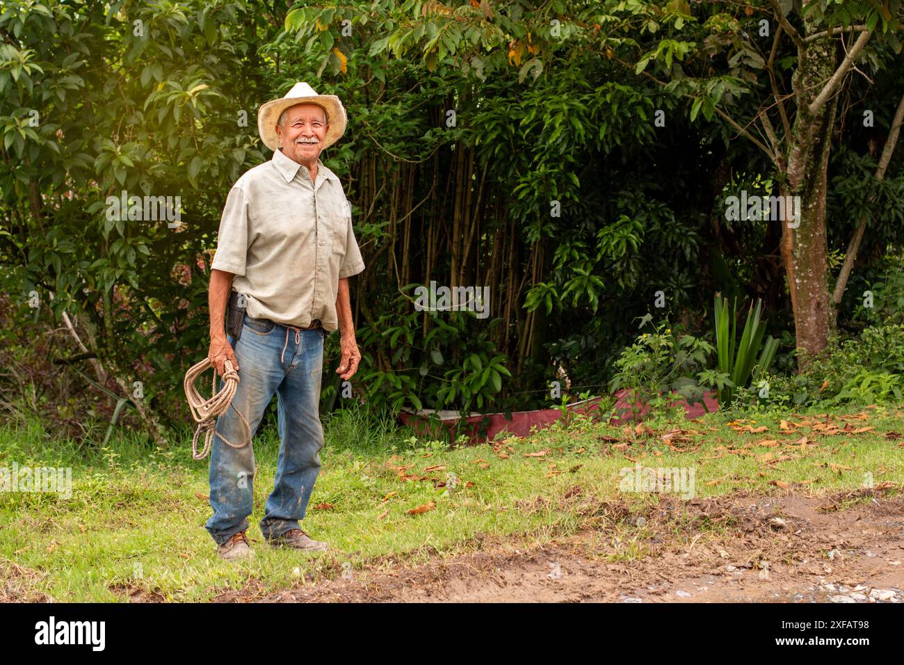 happy senior farmer in the field. old man with smiling hat Stock Photo